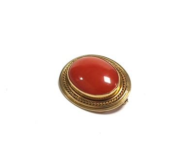 Lot 101 - A 9ct gold mounted cabochon coral brooch