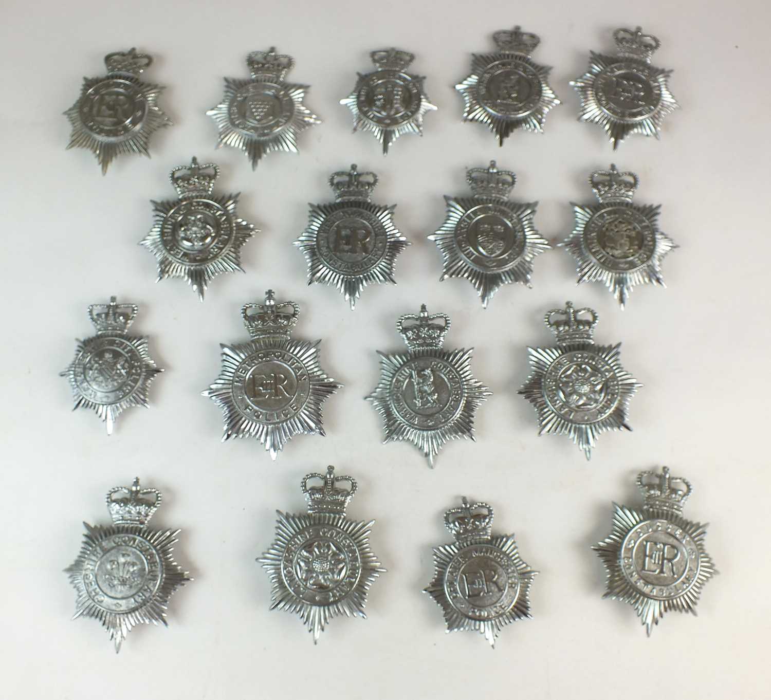 Lot 259 - Seventeen Queen's Crown Police helmet plates