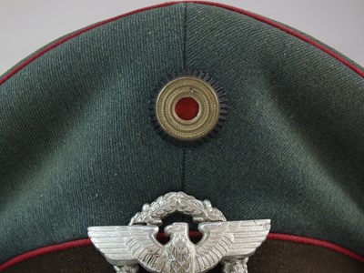 Lot 319 - A scarce German Third Reich Municipal Protection Police visor cap