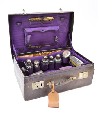 Lot 57 - A collection of silver and white metal mounted dressing table wares within travelling case