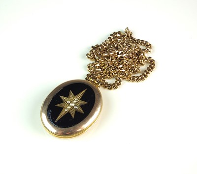 Lot 32 - A late 19th century seed pearl and black enamel oval locket