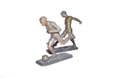 Lot 576 - After Fratin, a pair of unusual bronze patinated spelter footballers, 27cm high