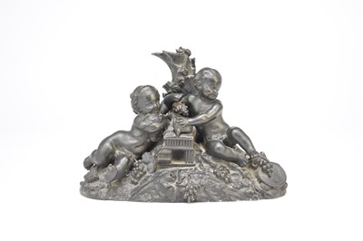 Lot 531 - Probably Coalbrookdale, a bronze group of two cherubs below a tree stump, 21cm long