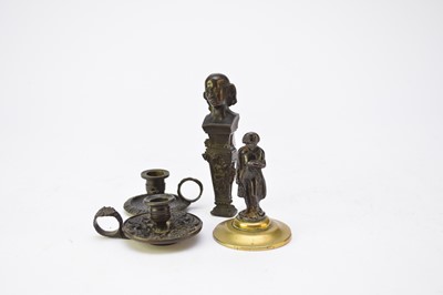 Lot 579 - Probably Coalbrookdale, two miniature bronze chambersticks, with a seal and a figure of Napoleon (4)