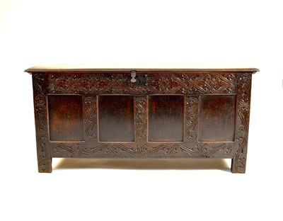 Lot 665 - An 18th century four panel carved oak coffer