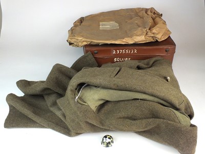 Lot 48 - 1944 dated British Battledress Greatcoat and a German pottery helmet
