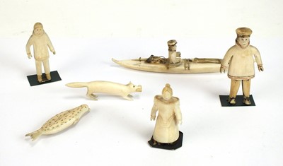 Lot 529 - A collection of early 20th century Inuit bone carvings, including a fisherman in a kayak (6)