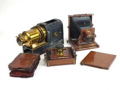 Lot 635 - An Edwardian magic lantern and two bellows cameras