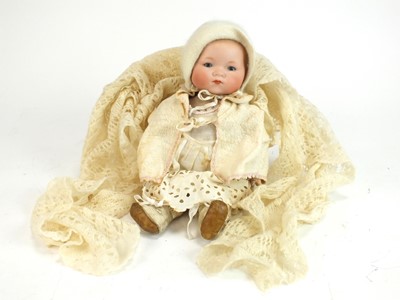 Lot 555 - An Armand Marseille porcelain headed doll of an infant