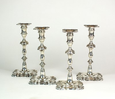Lot 5 - A near set of four cast silver candlesticks