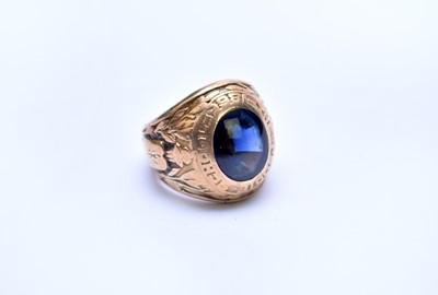 Lot 116 - A yellow metal and untested sapphire American High School signet ring