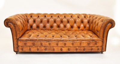 Lot 741 - A tan leather Chesterfield sofa, 20th century