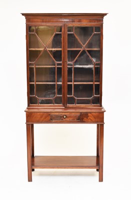 Lot 696 - An Edwardian mahogany glazed bookcase on associated stand