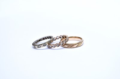 Lot 121 - A 9ct band and two eternity rings