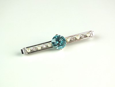 Lot 54 - A blue zircon, diamond and seed pearl bar brooch