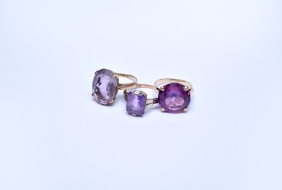 Lot 110 - Two amethyst rings and a synthetic sapphire ring