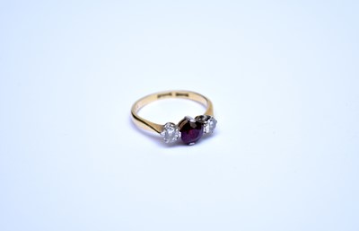 Lot 89 - A three stone ruby and diamond ring