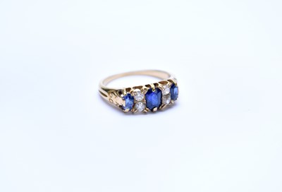 Lot 101 - A seven stone sapphire and diamond ring