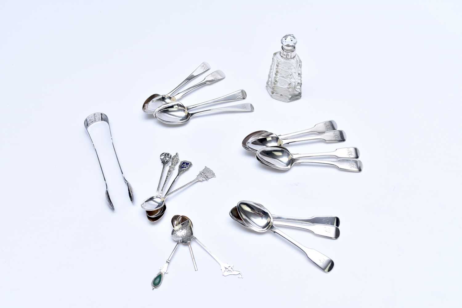 Lot 56 - A collection of silver and white metal spoons and sugar tongs