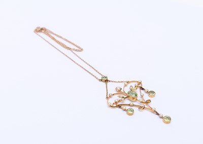 Lot 197 - An early 20th century peridot and seed pearl pendant on chain