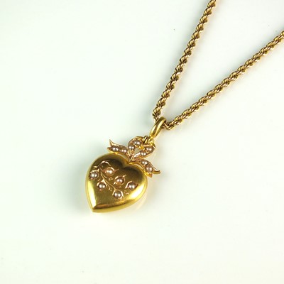 Lot 69 - A late 19th/early 20th century seed pearl heart shaped pendant on chain