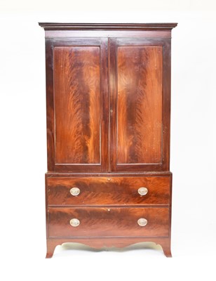 Lot 300 - An early 19th century mahogany linen press