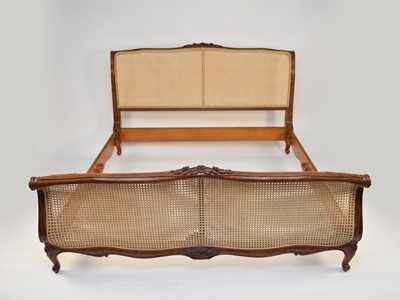 Lot 310 - And So to Bed, London: A Louis XV style carved hardwood bergere bedroom suite