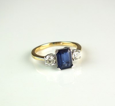 Lot 80 - An 18ct gold three stone sapphire and diamond ring