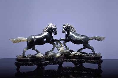 Lot 69 - A pair of Chinese grey-green jade figures of horses, 20th century