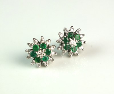 Lot 86 - A pair of 18ct white gold emerald and diamond cluster earrings