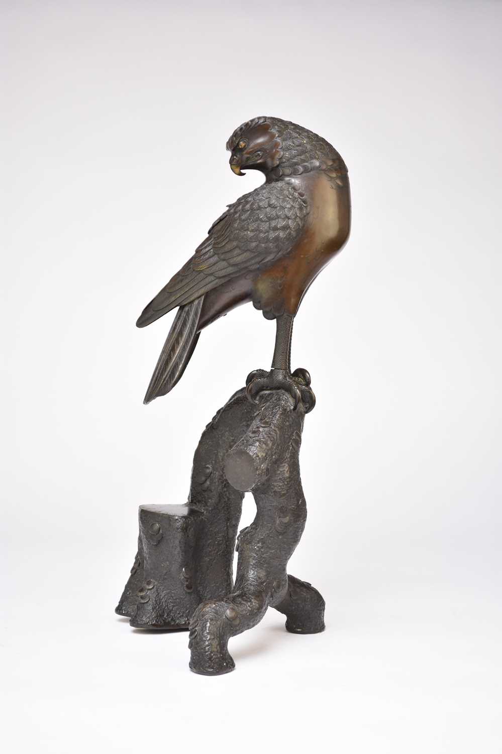 102 - A Japanese bronze figure of an eagle perched on a branch