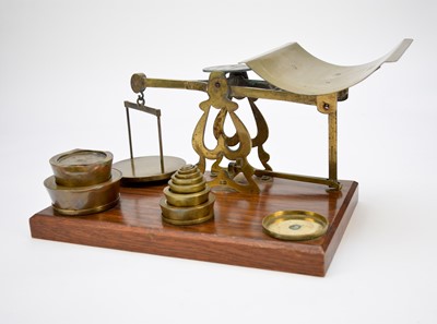 Lot 444 - A late Victorian/Edwardian set of brass counter-top scales