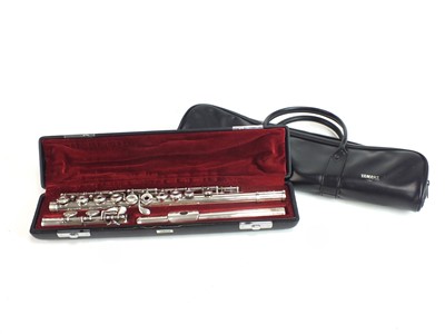 Lot 602 - A Yamaha silver flute with carrying case and stand