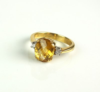 Lot 86 - An 18ct gold citrine and diamond ring