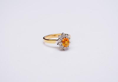 Lot 138 - An 18ct gold yellow sapphire and diamond oval cluster ring