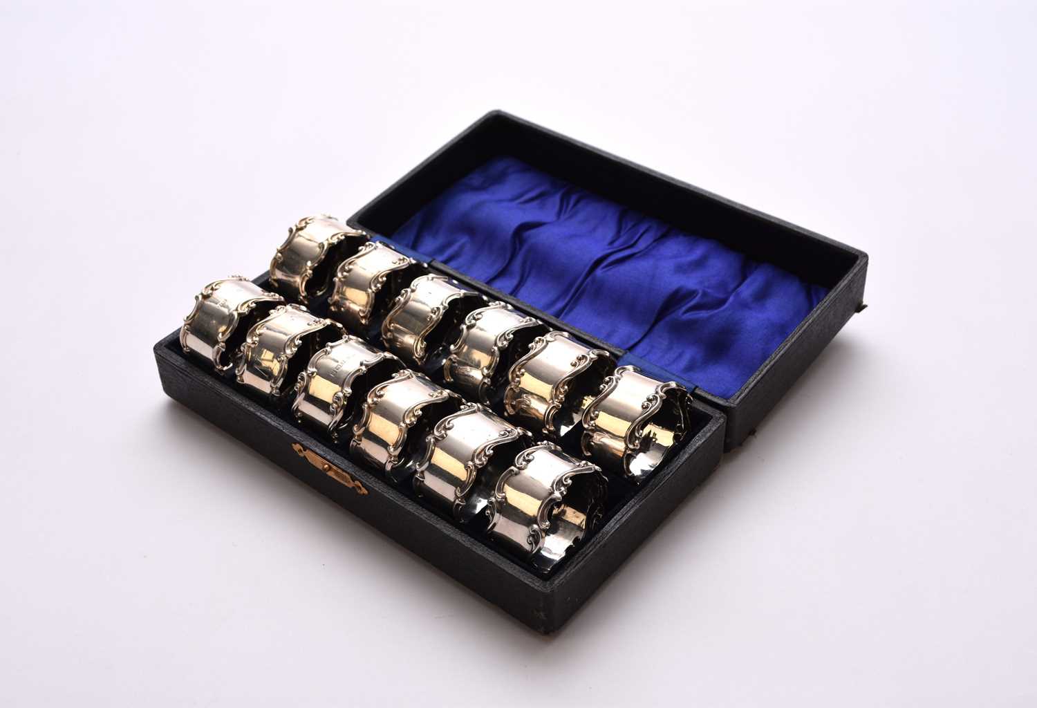 Lot 60 - A cased set of twelve silver napkin rings