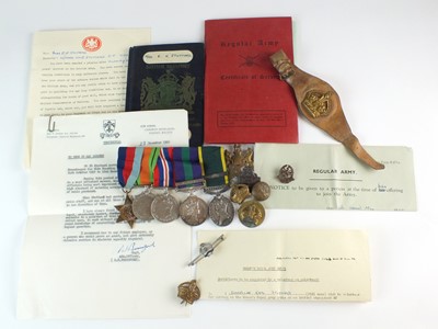 Lot A group of WWII medals, titles, badges, paperwork & two WWI photographs