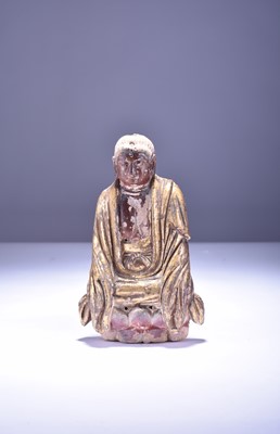Lot 5 - A Chinese stoneware altar figure of Buddha, Ming Dynasty