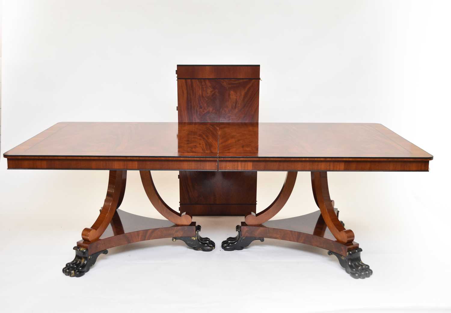 Lot 748 - A Clive Christian flame mahogany twin-pedestal extending dining table