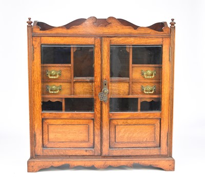 Lot 429 - An Edwardian oak smokers cabinet