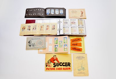 Lot 457 - A collection of cigarette cards to several albums