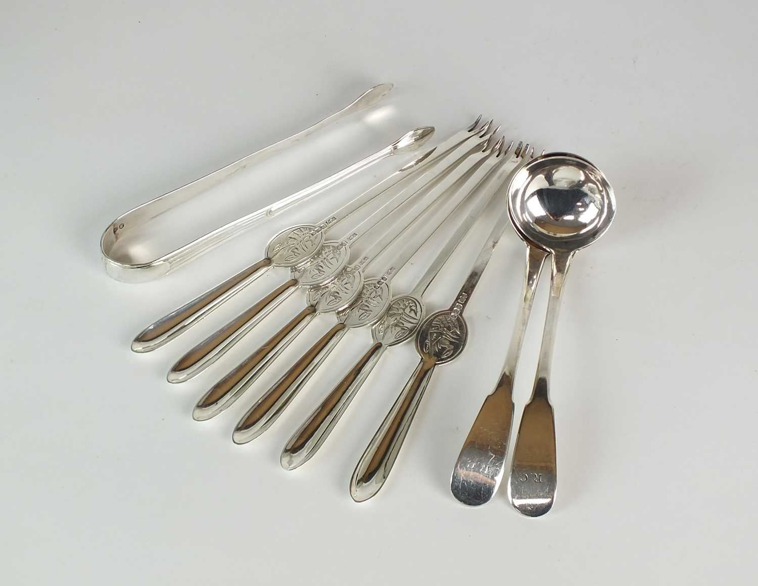 Lot 54 - A set of six silver lobster picks, two silver sauce ladles and a pair of silver sugar tongs