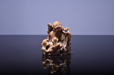Lot 567 - A Chinese soapstone figure of Budai, Qing Dynasty