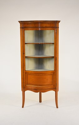 Lot 556 - An Edwardian inlaid satin birch glazed corner display cabinet