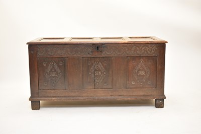 Lot 389 - A carved and dated 18th century oak coffer