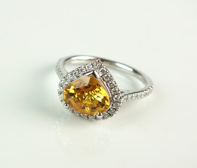 Lot 95 - An 18ct white gold heart shaped yellow sapphire and diamond cluster ring