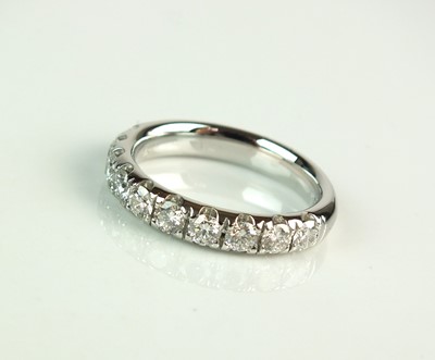Lot 97 - A platinum diamond half hoop eternity ring