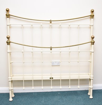 Lot 431 - A Seventh Heaven painted cast iron and polished brass 4'6" bedstead
