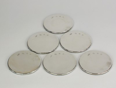 Lot 9 - A set of six silver mounted coasters