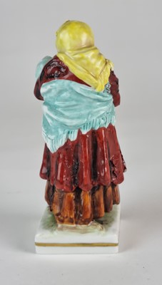Lot 273 - German porcelain figure of Russian peasant woman with baby, 19th century